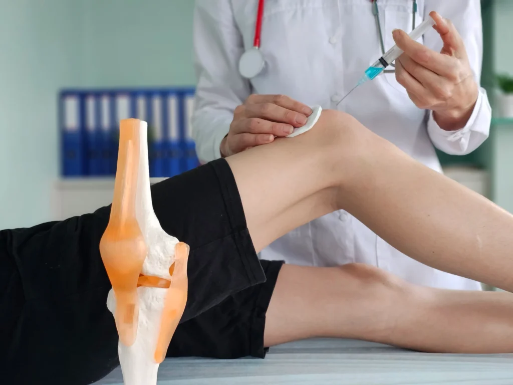 Doctor doing stem cell therapy on a patient's knee after the injury concept